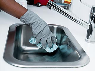 photo of hand cleaning kitchen sink